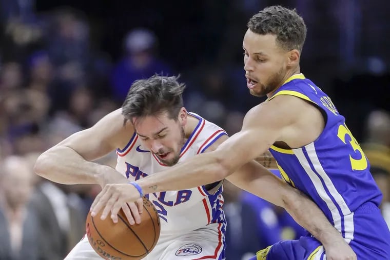 Golden State Warriors guard Stephen Curry pressures Sixers guard T.J. McConnell during the third-quarter on Saturday, November 18, 2017 in Philadelphia. YONG KIM / Staff Photographer