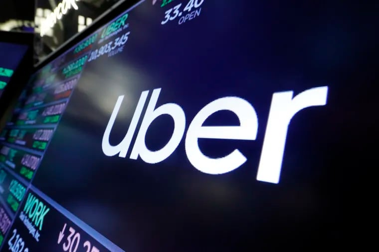 In this Friday, Aug. 16, 2019 file photo, the logo for Uber appears above a trading post on the floor of the New York Stock Exchange.