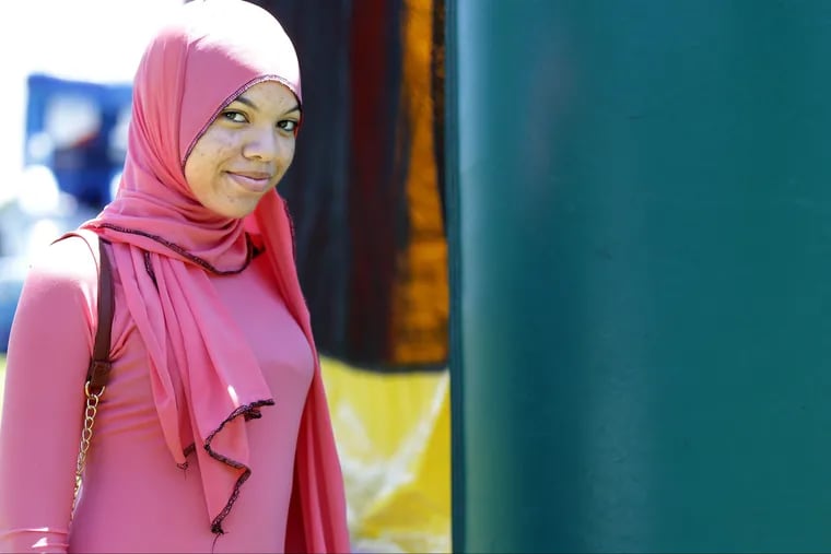 Angel Owens, 17, of North Philadelphia, attends the Eid festivities in Chalmers Park.