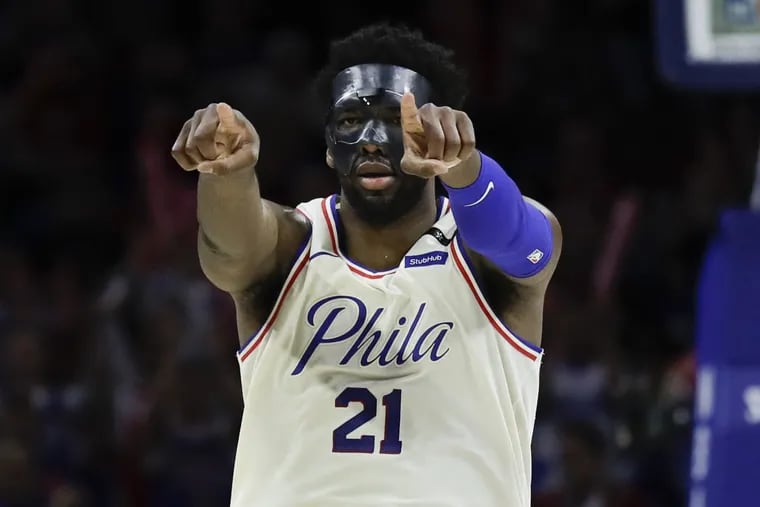Sixers center Joel Embiid points to fans after making a basket in the fourth quarter against the Heat in Game 5 of the Eastern Conference quarterfinals on Tuesday.