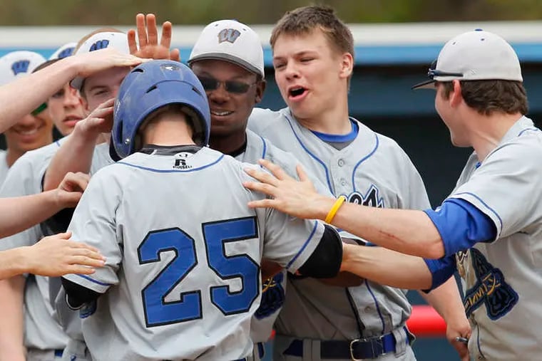 Williamstown's Justin Keegan (25) gets a hero's welcome after his homer in the sixth.