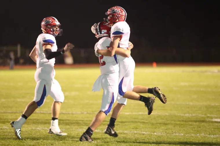 Neshaminy’s Oleh Manzyk (right) is lifted up by quarterback Brody McAndrew after his touchdown in the 1st quater against Pennsbury on Oct. 27,