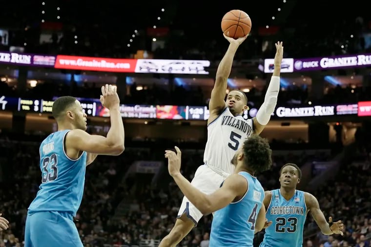 Villanova #5 Phil Booth shoots as Georgetownâ€™s # 33 Trey Mourning, # 4 Jagan Mosely and # 23 Josh LeBlanc look on in the 2nd half of the Georgetown vs. Villanova University NCAA mens basketball game at Wells Fargo Center in Phila., Pa.on February 3, 2019.