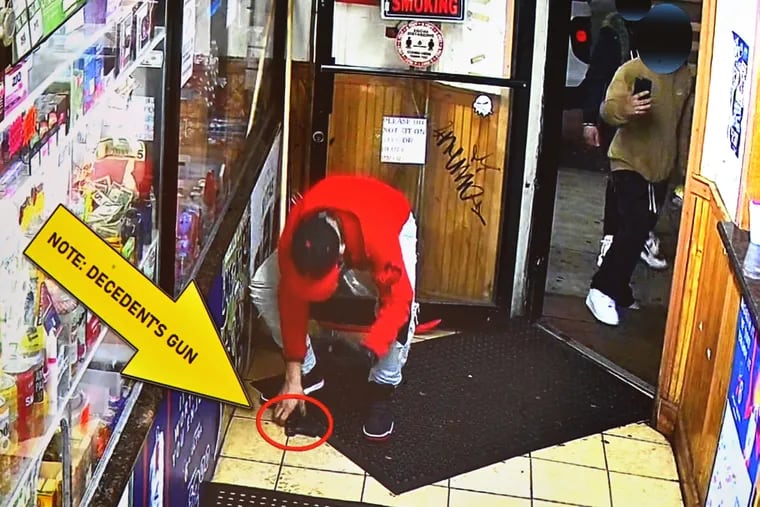 A police annotated frame grab of a video displayed at a Philadelphia Police Department news conference Tuesday showing the Fairhill shooting that left an officer wounded and a suspect dead. (This is part of the video from after the gunshots, shows what appears to be a handgun on the floor as man in a red sweatshirt — whom police identified as Jose Quiñones-Mendez — picks up the loose weapon).