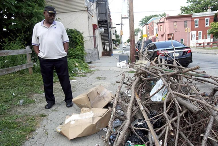 Talmadge Belo points out trash in his North Philadelphia neighborhood on June 15, 2015. ( STEPHANIE AARONSON / Staff Photographer )
