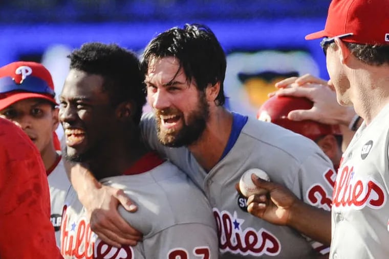 Cole Hamels hugs centerfielder Odubel Herrera (37), who made the final out of the game on a running, slipping catch on the warning track to complete Hamels' no-hitter. MATT MARTON / AP