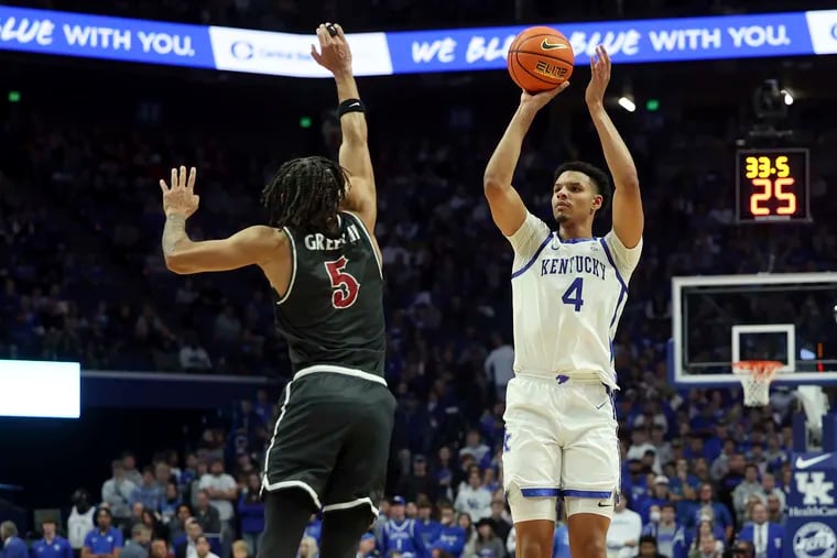 Kentucky's Tre Mitchell shoots over the defense of St. Joseph's Lynn Greer III during the first half in Lexington, Ky.
