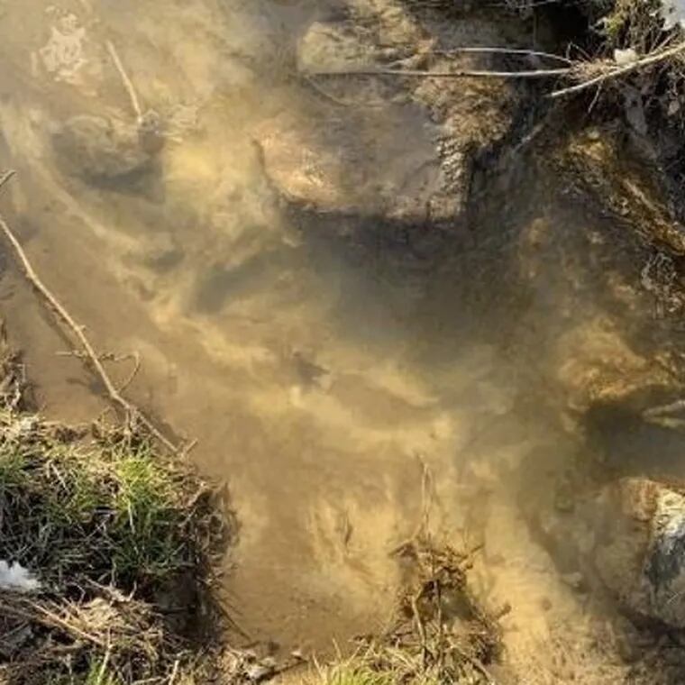 A Pennsylvania Department of Environmental Protection inspector's report from February 16 2024, shows white coloration of a tributary to Marsh Creek Lake behind homes on Waterview Road, Upper Uwchlan Township, Chester County. The substance was emitted near a former sinkhole related to the Mariner East 2 pipeline.
