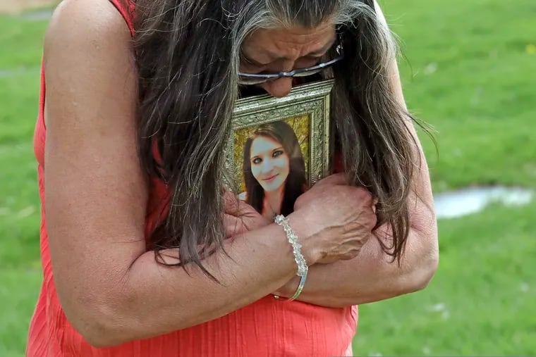 Melany Zoumadakis clutches a photo of her daughter, Tanna Jo Fillmore, on Friday, April 26, 2019, in Salt Lake City. Fillmore killed herself in the Duchesne County Jail in 2016, after repeatedly calling her mother, saying she was being denied her prescription medicines that had stabilized her. Her mother has filed suit. (AP Photo/Rick Bowmer)