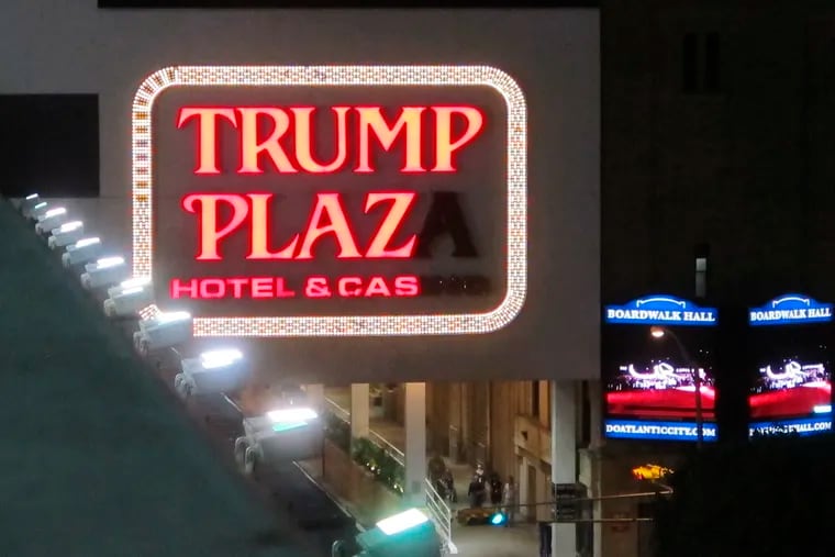 This Sept. 10, 2014 photo shows a partially burned-out sign on the exterior of the Trump Plaza casino in Atlantic City.