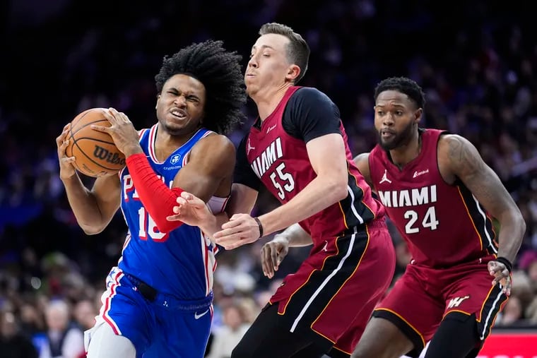 Philadelphia 76ers' Ricky Council IV, left, tries to get past Miami Heat's Duncan Robinson (55) and Haywood Highsmith (24) during the second half of an NBA basketball game, Wednesday, Feb. 14, 2024, in Philadelphia.