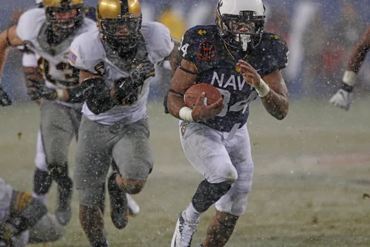 Navy's Noah Copeland breaks through the Army line in the second quarter and raced into the endzone. (Michael Bryant/Staff Photographer)