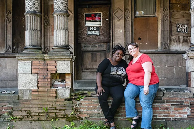 Diana Denson, left, and Jennifer Robinson are trying to organize restoration effort for the Conkling-Armstrong House on West Tioga Street in North Philadelphia. The house once belonged to the owners of a local terra cotta manufacturing plant, and was where Denson grew up as a foster child. ( MATTHEW HALL / Staff Photographer )