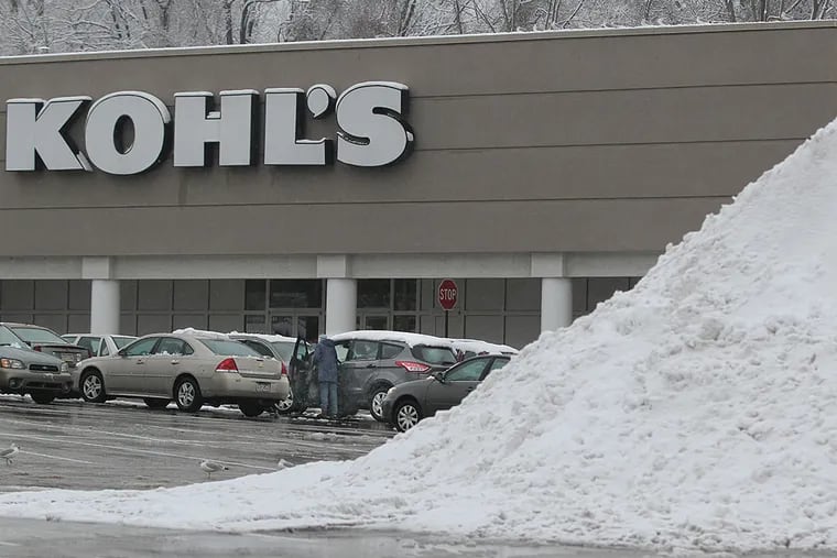 Snow is piled high and parking spots are cleared at the Andorra Shopping Center, but Tuesday's weather kept customers away from Kohl's and other stores. MICHAEL BRYANT / Staff Photographer