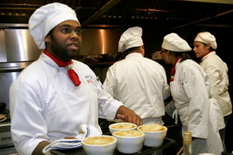 Lennie Payne, a student at JNA Institute of Culinary Arts in Philadelphia, holds French onion soup he helped make. The institute&#0039;s restaurant serves lunch and dinner Tuesdays through Fridays.