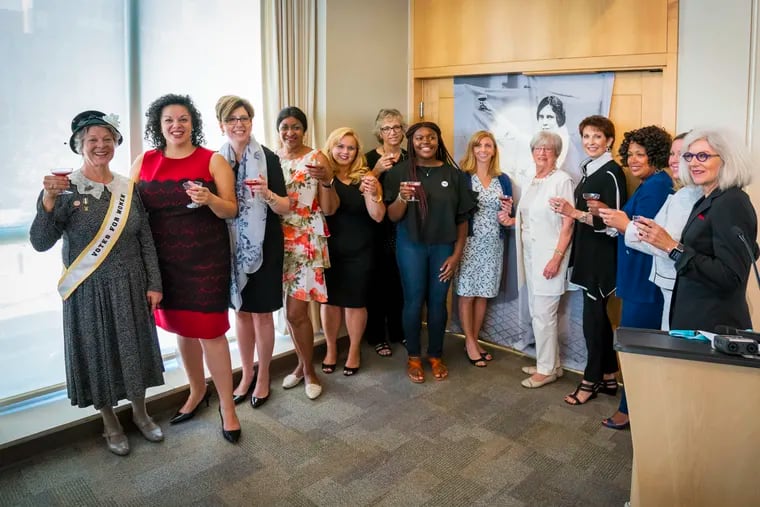 Participants of Drexel University's Vision 2020 women's equality program take their annual Toast to Tenacity for Women’s Equality Day in 2018. They are raising glasses of grape juice to toast women’s progress, as suffragist Alice Paul did in 1920 when the 19th Amendment to the U.S. Constitution was passed.