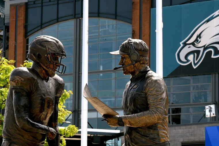 A statue immortalizing former Eagles quarterback and Super Bowl MVP Nick Foles, left, asking former head coach Doug Pederson if he “wants Philly Philly?” will go down as arguably the best moments in Eagles Super Bowl history.