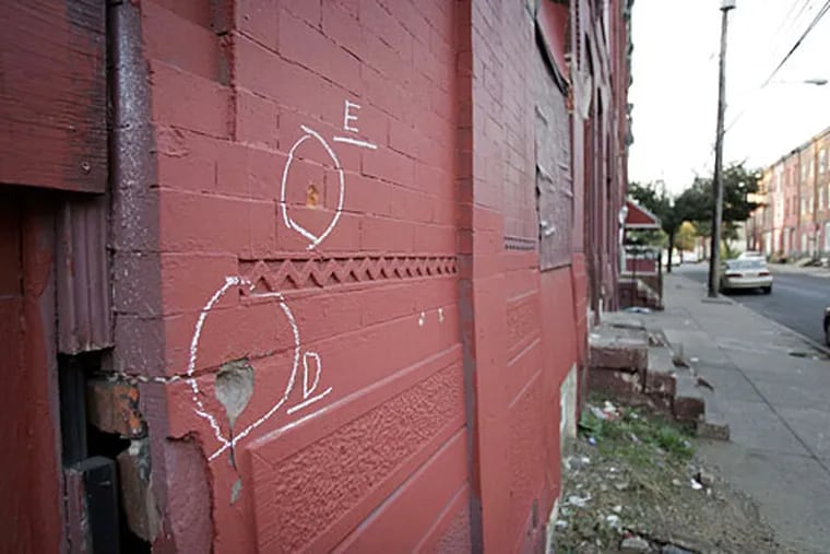 Bullet strike marks in a wall at 17th and Dauphin Streets where Daniel Giddings was shot by police in a gun battle Tuesday afternoon.