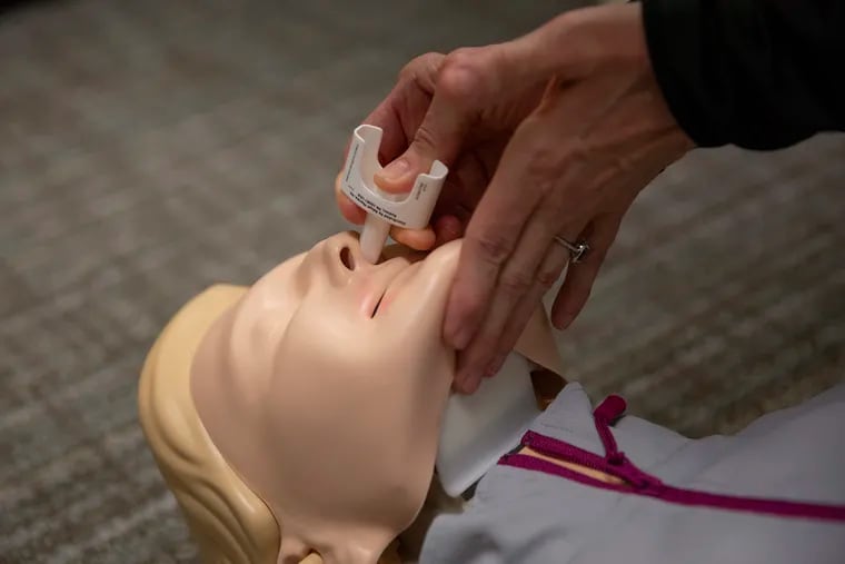 Bonnie Milas, an anesthesiologist at Penn, demonstrates how to administer Narcan on a mannequin in her office at the Hospital of the University of Pennsylvania on Thursday, April 18, 2019. Milas lost her son to an overdose and has since become an advocate for overdose prevention.