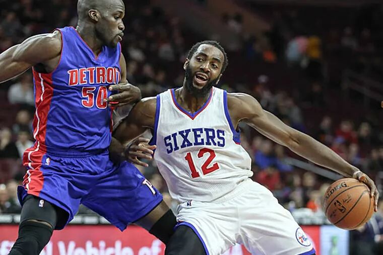 Sixers'  Luc Richard Mbah a Moute drives on Pistons' Joel Anthony during the 1st quarter at the Wells Fargo Center in Philadelphia, Wednesday,   March 18, 2015.   (Steven M. Falk/Staff Photographer )