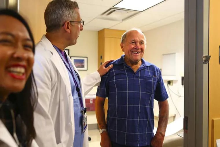 Edwin Dixon, far right, shares a light moment with Dr. Mark Reisman, center, and Liz Perpetua during a checkup at the University of Washington Regional Heart Center on August 4, 2015. (John Lok/Seattle Times/TNS)