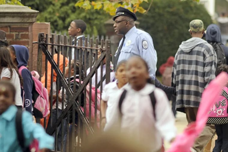 School police officer Eric Cosby, on duty Thursday outside H.R. Edmunds Elementary School, faced assault and other charges in 2008 after allegedly driving his car into someone. (Tom Gralish / Staff Photographer)