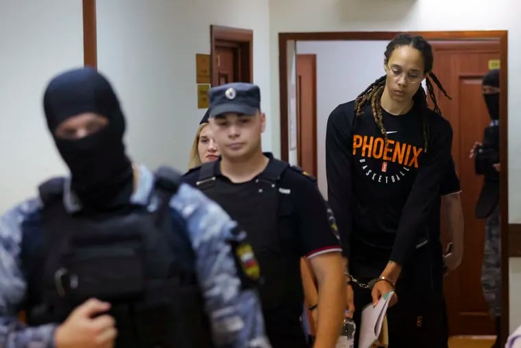 WNBA star and two-time Olympic gold medalist Brittney Griner is escorted to a courtroom for a hearing, in Khimki just outside Moscow, Russia, on Wednesday.