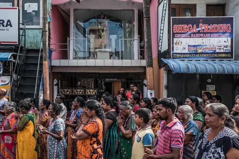 A group of residents pray outside St. Anthony's Church in Kochikade on April 23, 2019, in Colombo, Sri Lanka. St. Anthony's Church was attacked during a bomb blast on Easter Sunday.
