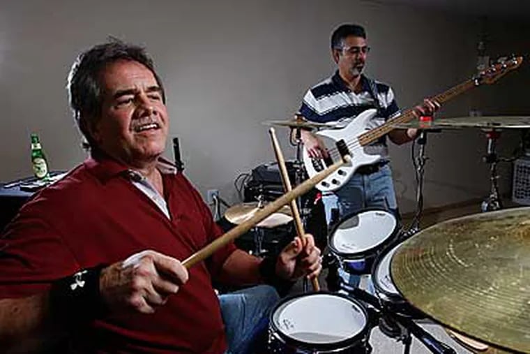 Jay Strunk (left), an unemployed executive, drums during a jam with bass guitar player Gerry Franciosa (right). Strunk says the band helps his relieve some of the stress that he has because of his unemployment. ( Michael S. Wirtz / Staff Photographer )