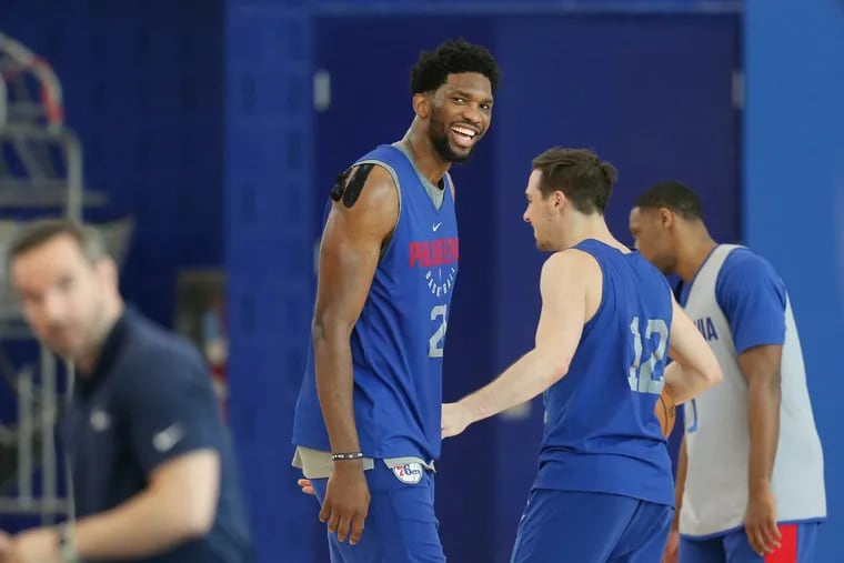 Sixers center Joel Embiid laughs during practice on Thursday.