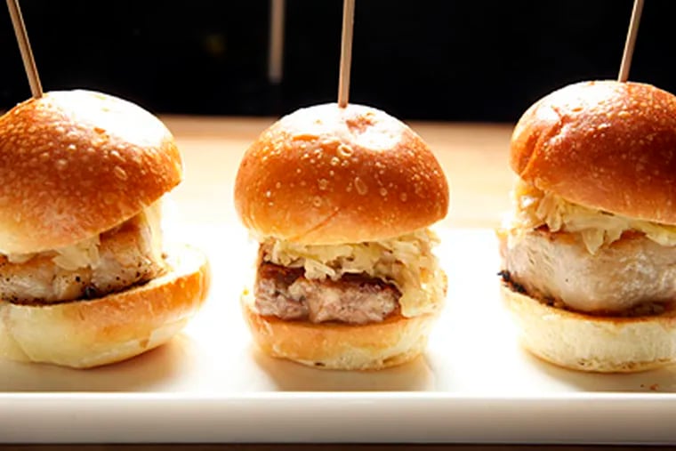 The meat in the pork belly sliders is braised to tenderness, crisped, and layered with house-cured kraut and homemade mustard. (Pork Belly Sliders at The Corner Restaurant in Philadelphia. (Laurence Kesterson / Staff Photographer)