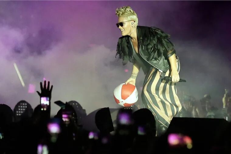 Pink tosses a beach ball back into the audience as her performance begins on the beach in Atlantic City, NJ on July 12, 2017.
