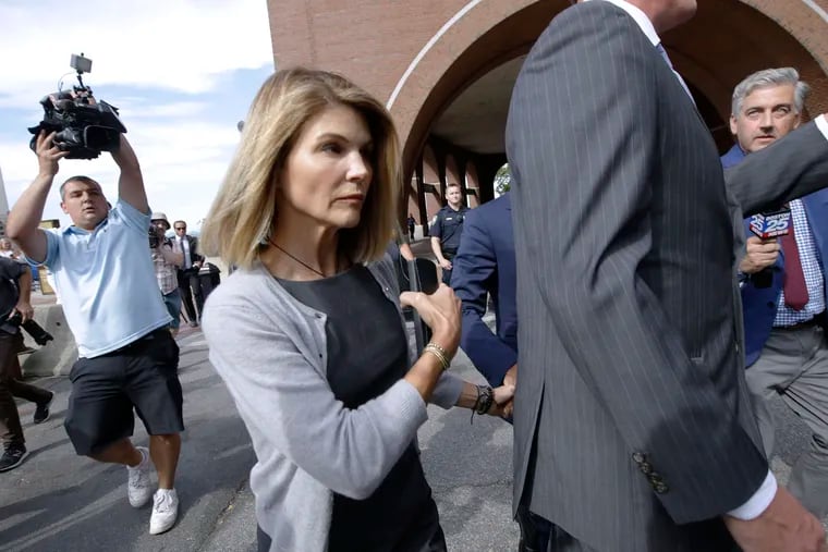 In this Aug. 27, 2019, file photo, actress Lori Loughlin departs federal court in Boston after a hearing in a nationwide college admissions bribery scandal. A new prosecution filing in the college admissions cheating case targets defense claims by Loughlin and her fashion designer husband Mossimo Giannulli.