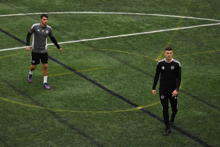 New Union assistant coach Ryan Richter works with new striker Julian Carranza (left) during the team's first official day of preseason practice at the 76ers' Chase Fieldhouse in Wilmington on Tuesday.