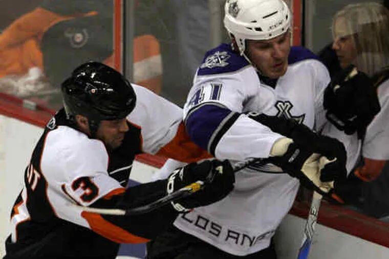 The Flyers&#0039; Glen Metropolit takes the Kings&#0039; Raitis Ivanans into the boards in the first period of the 2-0 win over Los Angeles. Jeff Carter&#0039;s second-period goal snapped a scoreless tie.