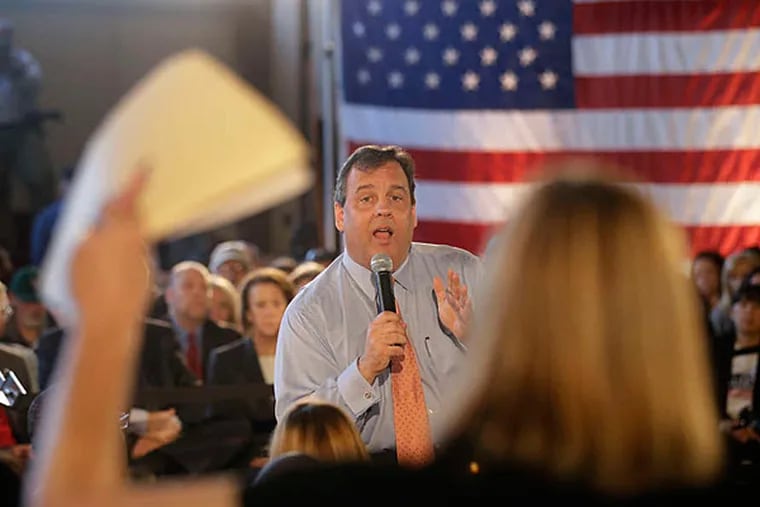 Gov. Chris Christie spars with Maura Collinsgru, a health-policy advocate, at a South River Town Hall-style meeting. Christie was also greeted by protesters at a town-hall-style meeting in Mount Laurel last week. (Mel Evans/Staff)