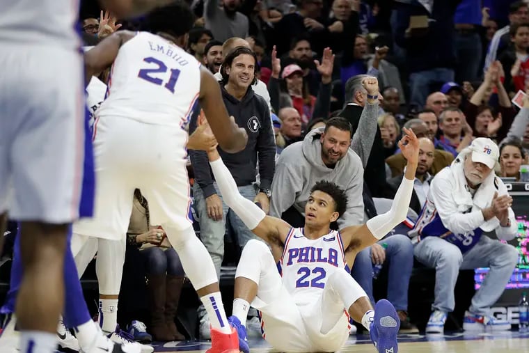 Sixers guard Matisse Thybulle raises his arms from the floor after making a three-point basket at the end of the first quarter against the Raptors.