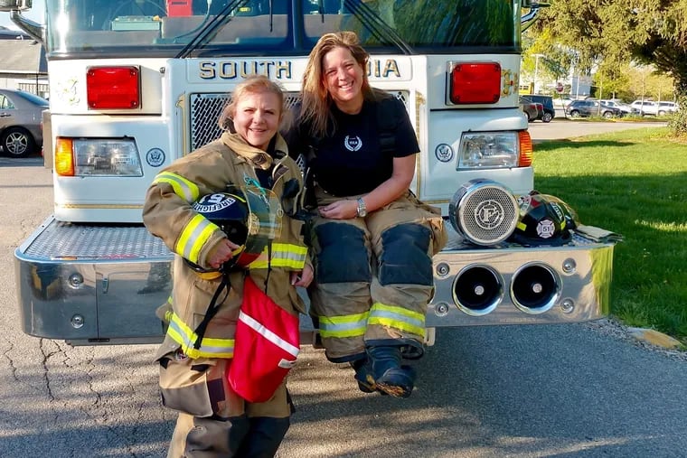 Volunteer firefighters Dora Giannakarios Preston, left, and Ellen Yarborough, after driving their truck to a fire call at Strath Haven Middle School in Wallingford, Pa., as members of South Media Fire Company the morning of Wednesday, April 24, 2019.