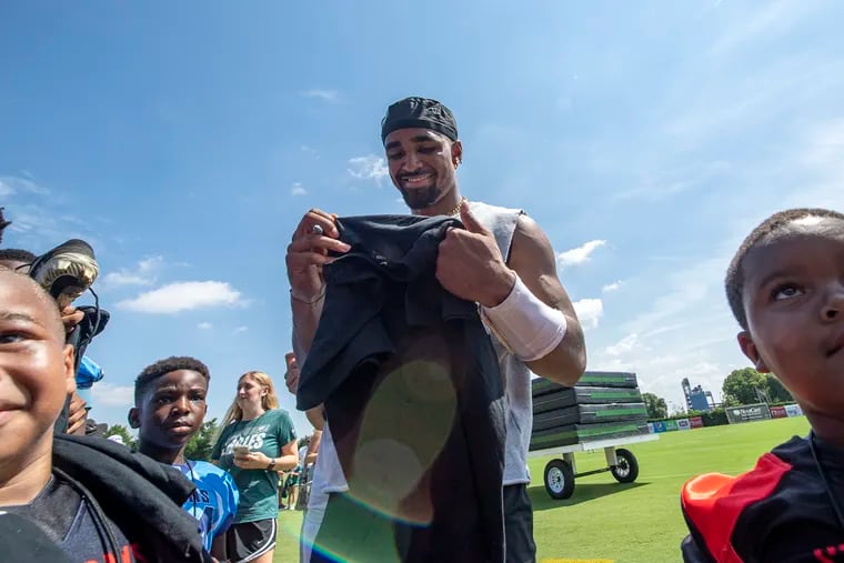 Eagles quarterback Jalen Hurts signs autographs during training camp on Tuesday.