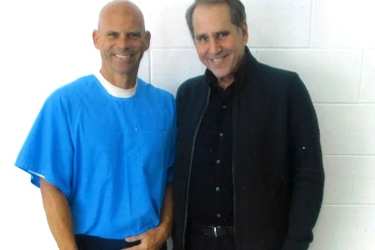 Journalist Robert Rand (right), once a member of CBS3's I-Team unit, visits with convict Lyle Menendez in a California prison.