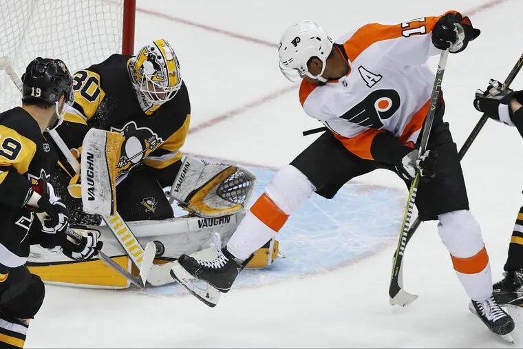Penguins goaltender Matt Murray stops a shot with the Flyers’ Wayne Simmonds  looking for a rebound in Pittsburgh’s 5-4 overtime win on March 25.