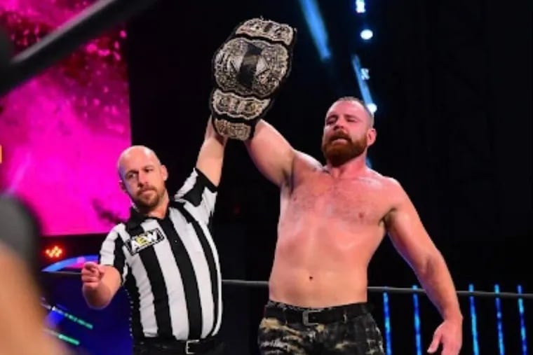 AEW referee Bryce Remsburg, left, worked his way from a Temple student selling t-shirts to being the main official for one of the largest outfits in professional wrestling.