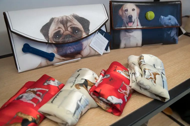 This Wednesday, Jan. 9, 2019, photo shows dog themed scarves and clutches that are on display for sale in the American Kennel Club Museum of the Dog's store in New York. The museum opens Feb. 8. (AP Photo/Mary Altaffer)