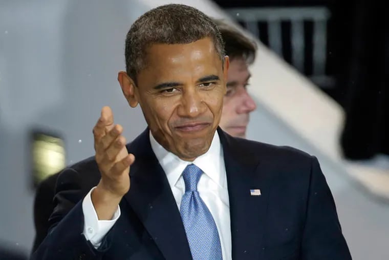 President Barack Obama watches the
inaugural parade, Monday, Jan. 21, 2013, in Washington.(AP Photo/Gerald Herbert)