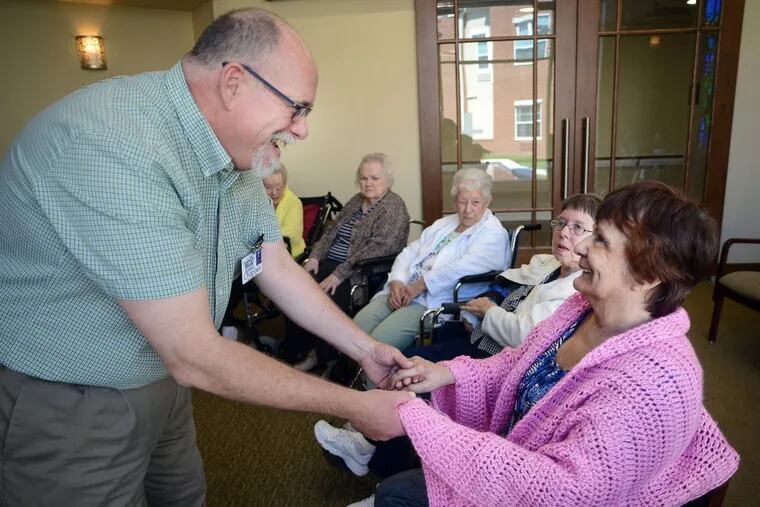 The Rev. Blaik Westhoff greets patient Carmen Reyes, 79, during Spirit Alive, a religious service for people with dementia.
