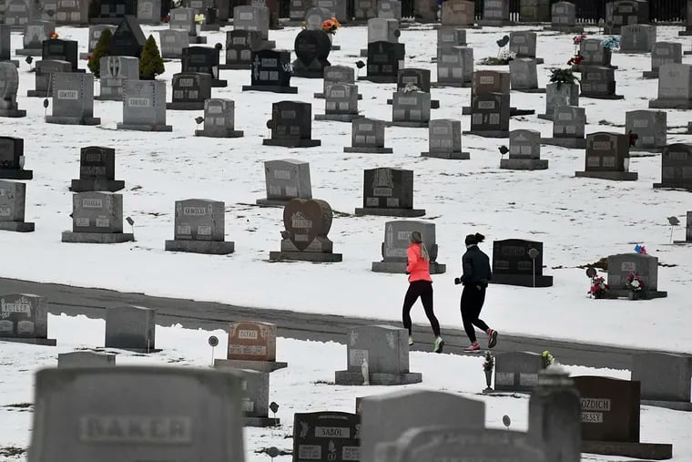 Two joggers running through Grandview Cemetery in Johnstown, Pa., in January 2020.