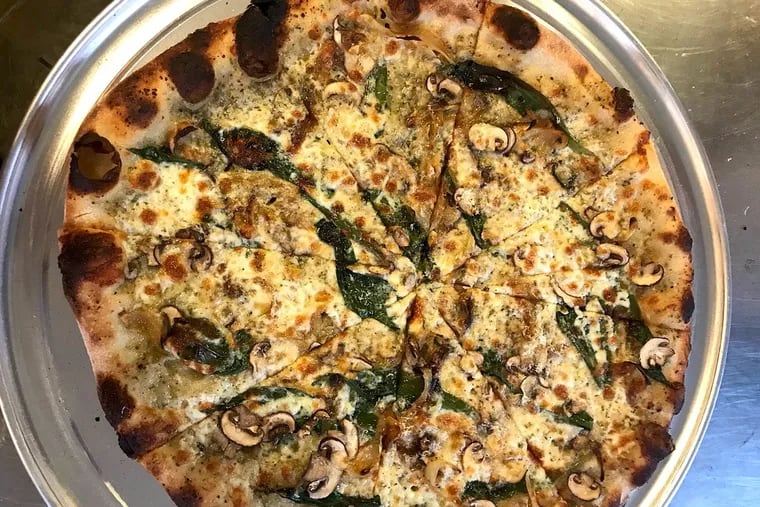 A sample specialty pizza from Pizza, 115 E. Girard Ave. in Fishtown, whose toppings include ramps, oyster mushrooms, and roasted onions.