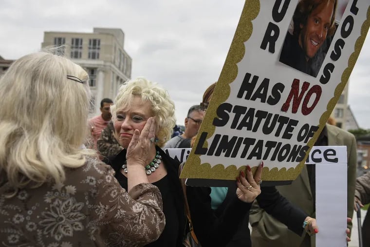 Cindy Leech (center) is greeted by Judy Deaven on the steps of the Pennsylvania State Capitol at the end of a march Sept. 24, 2018 in support of legislation to change the statute of limitations for child sex crimes. Both women have endured the deaths of sons who suffered from abuse by priests.