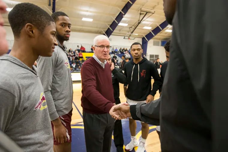 St. Joseph's Prep coach Speedy Morris (center) meets with officials before a 2017 game vs. Girard College. He plans to retire at the end of the St. Joseph's Prep basketball season, his 52nd as a head coach.