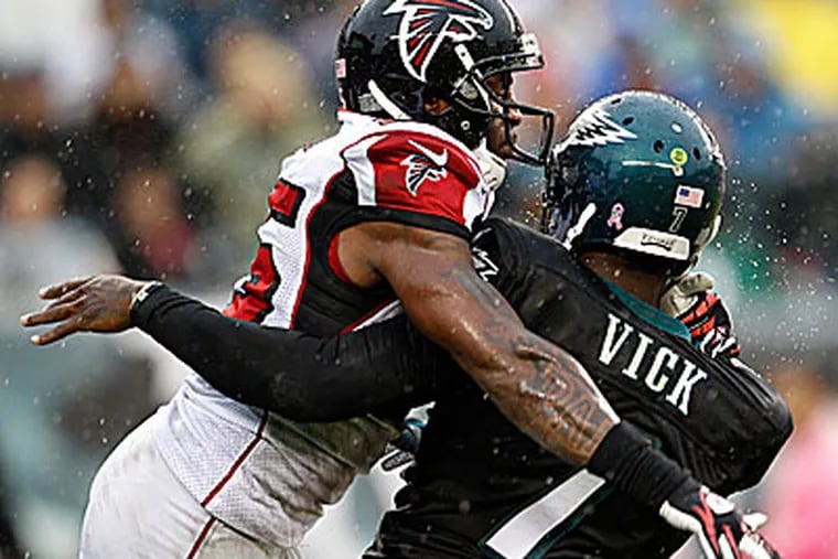 Eagles quarterback Michael Vick was sacked three times in the loss to the Falcons. (Yong Kim/Staff Photographer)
